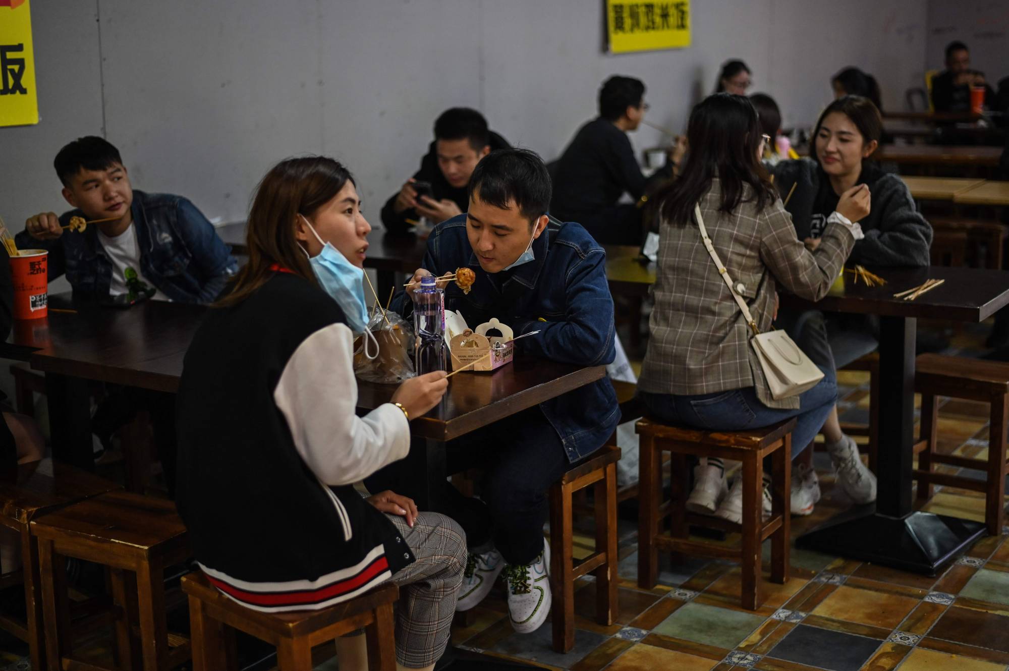 People eat at a restaurant in Shanghai on Oct. 25. | AFP-JIJI