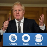 U.K. Prime Minister Boris Johnson speaks during a virtual news conference on Saturday to announce new lockdown restrictions in an effort to curb rising infections of the novel coronavirus.  | POOL / VIA AFP-JIJI