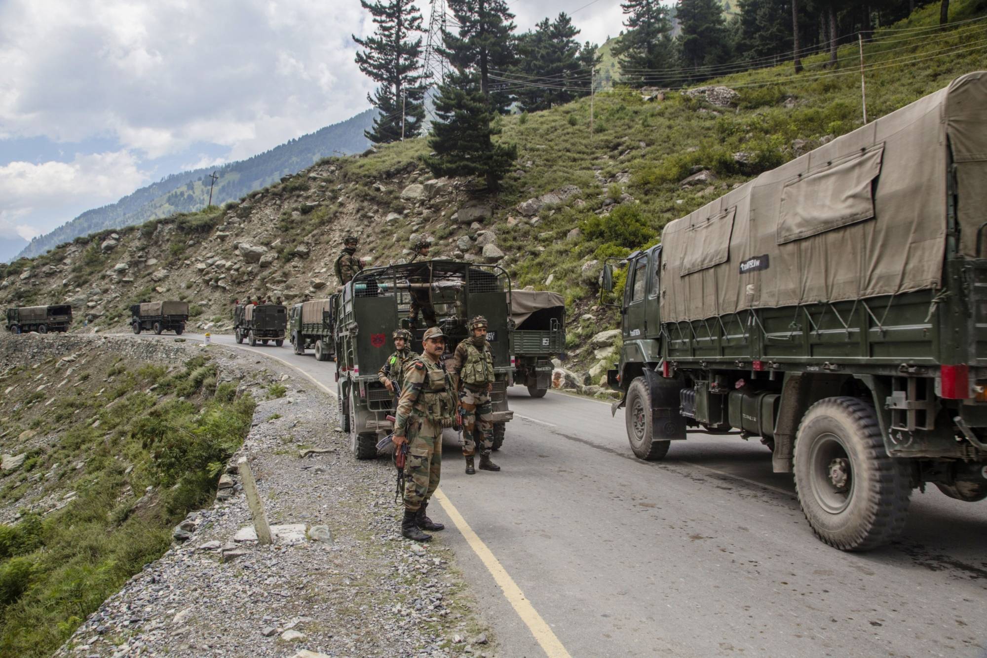 An Indian army convoy carrying reinforcements and supplies drives toward Leh on a highway bordering China in early September. | GETTY IMAGES / VIA BLOOMBERG