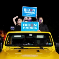 Supporters of U.S. Democratic presidential candidate Joe Biden and vice presidential nominee Kamala Harris take part in a drive-in campaign rally in Philadelphia on Sunday. | REUTERS