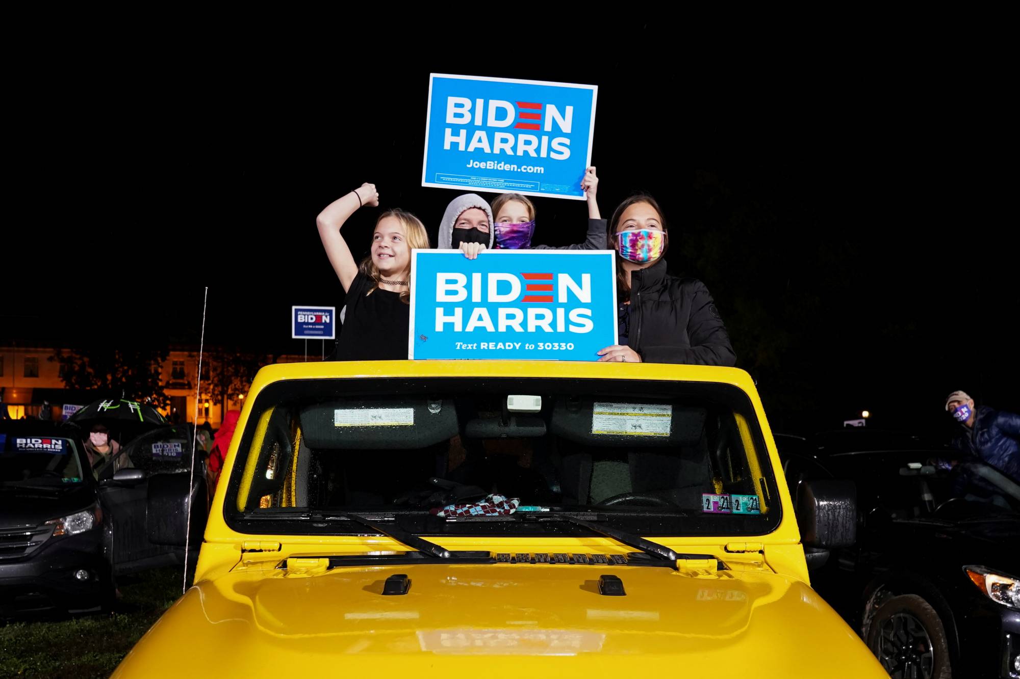 Supporters of U.S. Democratic presidential candidate Joe Biden and vice presidential nominee Kamala Harris take part in a drive-in campaign rally in Philadelphia on Sunday. | REUTERS