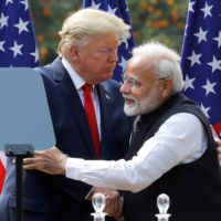 U.S. President Donald Trump and Indian Prime Minister Narendra Modi embrace after bilateral talks in New Delhi in February. Both major U.S. parties are actively courting Indian American voters, a significant number of whom reside in potential swing states like Texas and Pennsylvania. | REUTERS