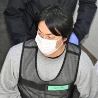 Former Japan handball player Daisuke Miyazaki appears at a police station in Nagoya on Tuesday after his arrest for allegedly assaulting a woman at a hotel. | KYODO