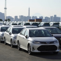 Toyota Motor Corp. vehicles bound for shipment are lined up at a port in Yokohama on Saturday. | BLOOMBERG