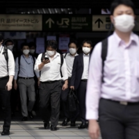 Japan set up a task force in February that focused on identifying clusters and stamping out widespread transmission, rather than trying to track down each individual case. | BLOOMBERG 