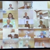 Bank of Japan Gov. Haruhiko Kuroda (top left) attends an online conference with heads of companies in the Chubu region Wednesday. | KYODO