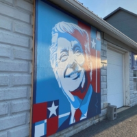 A mural of a smiling U.S. President Donald Trump commissioned by Randy Bunch, a commissioner in Fulton County, is seen on the side of a business on Election Day in McConnellsburg, Pennsylvania, on Tuesday.  | REUTERS