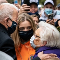 Former Vice President Joe Biden chats with a supporter as visits his childhood home in Scranton, Pa., on Election Day morning. | ERIN SCHAFF / THE NEW YORK TIMES