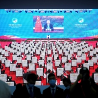 China\'s President Xi Jinping is seen on a screen in the media center as he speaks at the opening ceremony of the third China International Import Expo  in Shanghai on Wednesday. | REUTERS