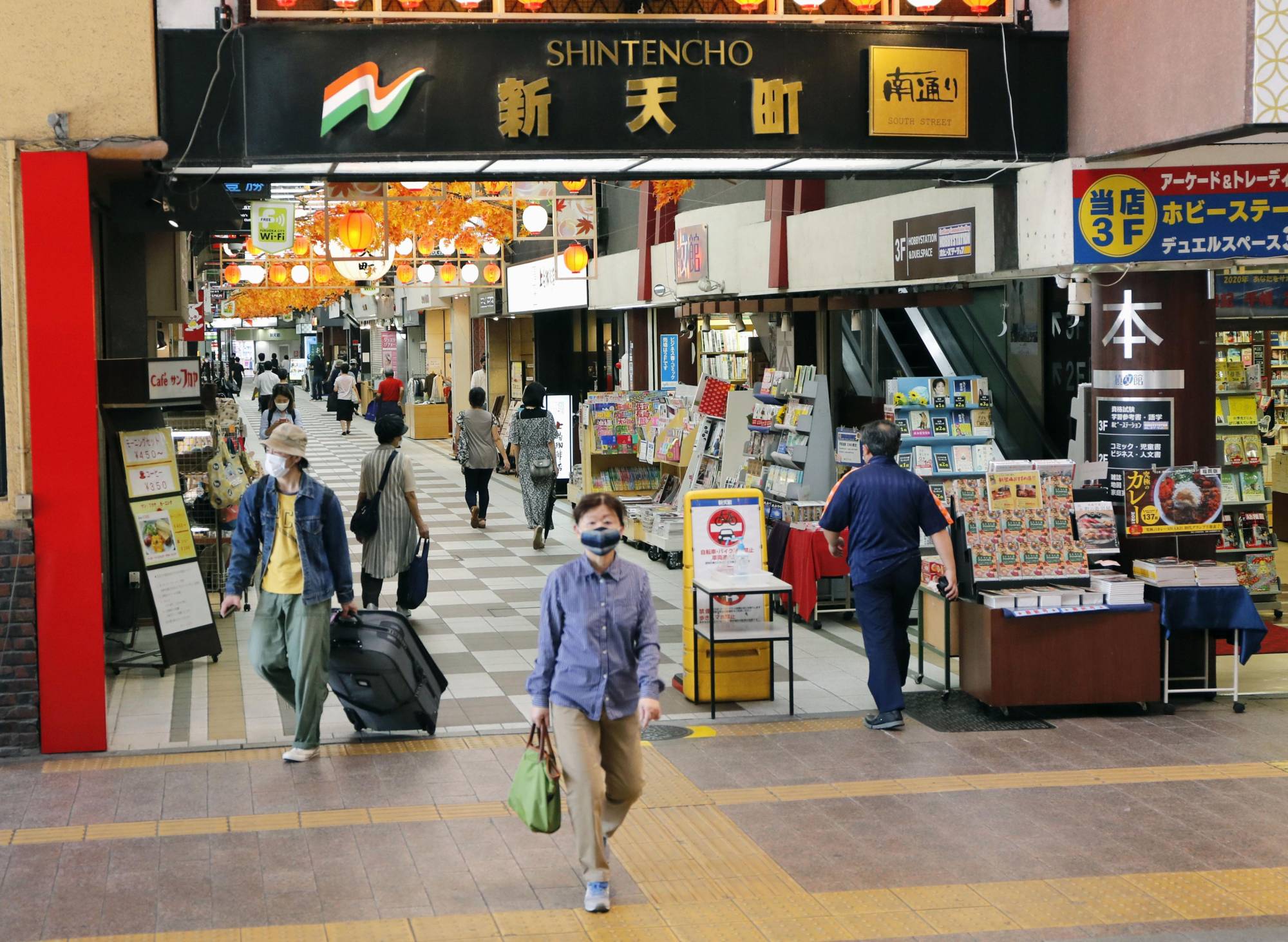 People walk in a shopping arcade in Fukuoka in September. Japan's household spending tumbled a real 10.2% in September from a year earlier. | KYODO
