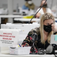 Officials process ballots at the Gwinnett County Voter Registration and Elections Headquarters, in Lawrenceville, Georgia, on Friday. | AP