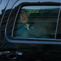 U.S. President Donald Trump watches from the motorcade as he returns to the White House in Washington after playing golf on Saturday. | AFP-JIJI