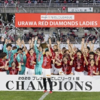Urawa\'s Hanae Shibata lifts the trophy as the team celebrates its third Nadeshiko League first-division title on Sunday at Urawa Komaba Stadium in Saitama. | KYODO