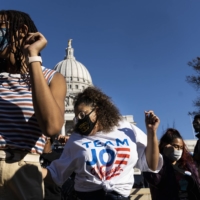 Biden supporters dance outside the Wisconsin State Capitol in Madison on Saturday.  | LAUREN JUSTICE / THE NEW YORK TIMES