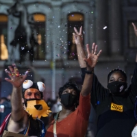 Biden supporters celebrate in the street in Philadelphia on Saturday.  | RUTH FREMSON / THE NEW YORK TIMES