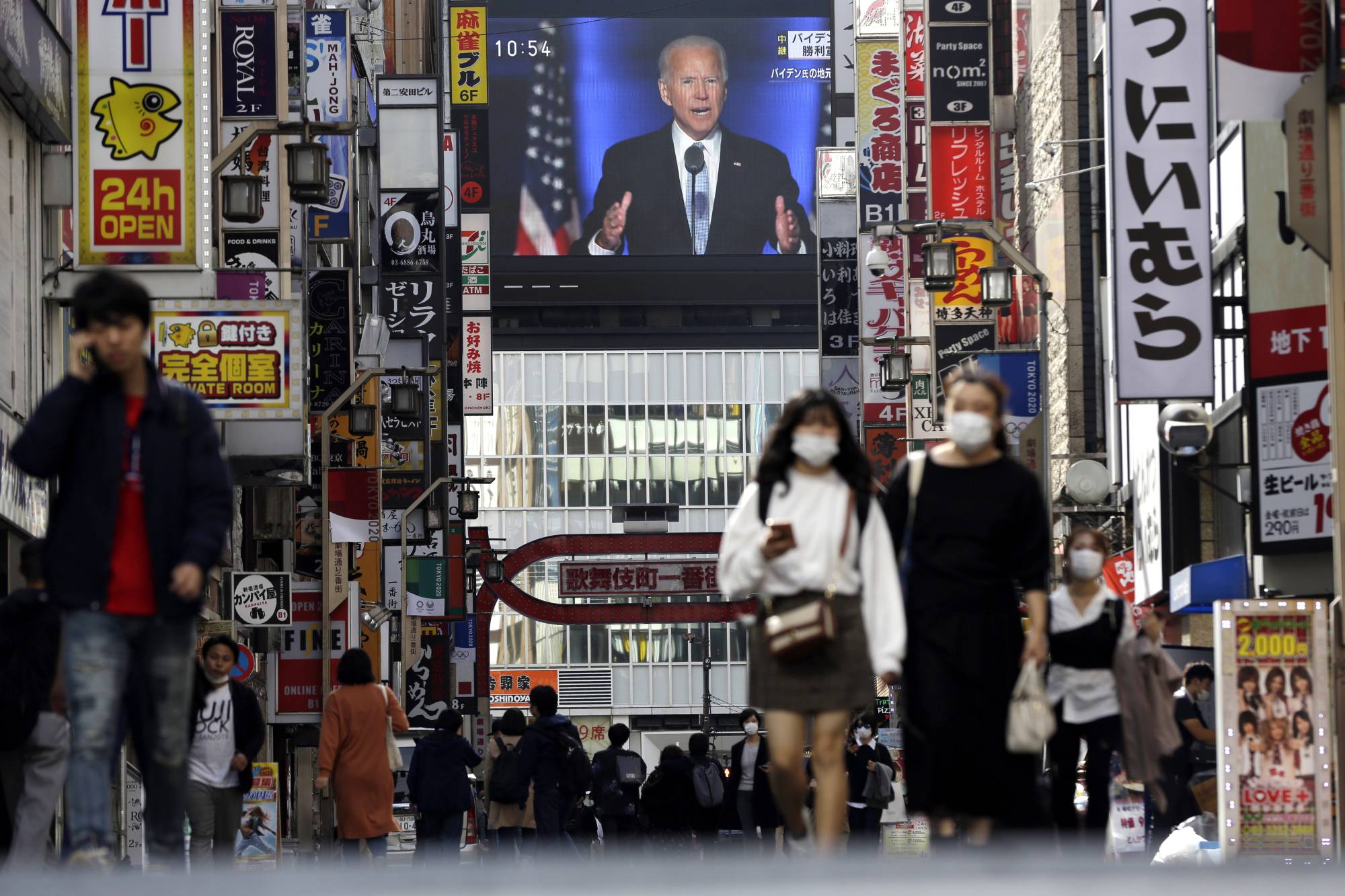 A screen shows a live broadcast of U.S. President-elect Joe Biden speaking Sunday, in Tokyo's Shinjuku Ward. | AP