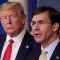 U.S. Defense Secretary Mark Esper address the daily White House coronavirus response briefing as President Donald Trump listens at the White House in Washington in March. | REUTERS