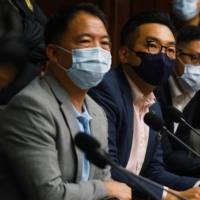 Pro-democratic Hong Kong legislators including Wu Chi-wai, Alvin Yeung and Lam Cheuk Ting give a news conference Monday as they threaten mass resignation amid reports that Beijing plans to disqualify some opposition lawmakers. | REUTERS 