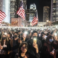 Protesters in Hong Kong gather in November 2019 to support legislation in the United States requiring American officials to assess Hong Kong’s autonomy from mainland China. | LAM YIK FEI / THE NEW YORK TIMES