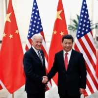 Chinese President Xi Jinping greets Joe Biden, then the U.S. vice president, at the Great Hall of the People in Beijing in 2013. | REUTERS 