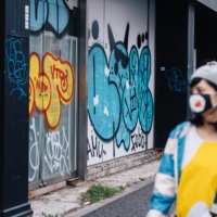 A woman walks past graffiti in the Harajuku neighborhood of Tokyo. | STEPHAN JARVIS
