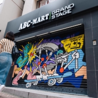 A woman walks past a painted shop front in Tokyo\'s Shibuya Ward. | STEPHAN JARVIS
