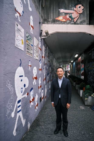 Shibuya Mayor Ken Hasebe stands beside one of the pieces commissioned by the local authority as part of the Shibuya Arrow Project. | STEPHAN JARVIS 