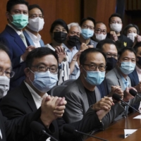 Pro-democracy lawmakers in Hong Kong pose before a news conference at the Legislative Council on Monday.  | AP