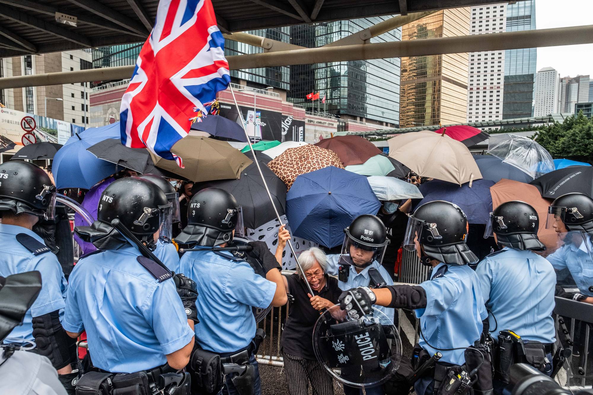 Police officers surround Alexandra Wong during protests outside the Legislative Council building in Hong Kong in June 2019.  | LAM YIK FEI / THE NEW YORK TIMES