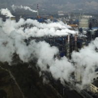 Smoke and steam rise from a coal processing plant in Hejin, in central China\'s Shanxi Province, in 2019.  | AP