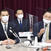 Japan Sports Agency Commissioner Koji Murofushi (left) and Japanese Olympic Committee President Yasuhiro Yamashita participate in a news conference on Friday at the Ministry of Education, Culture, Sports, Science and Technology. | KYODO