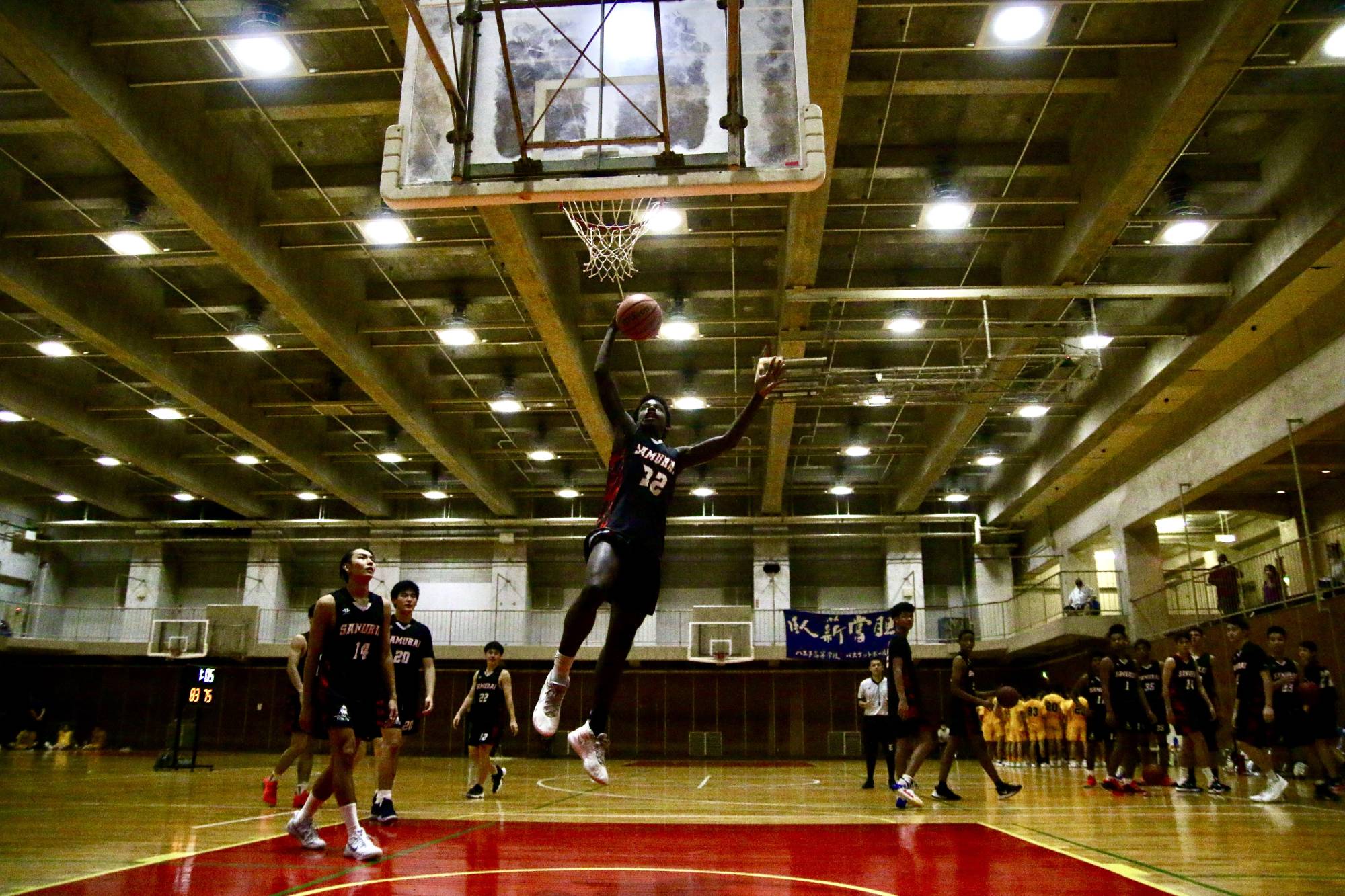 A Tokyo Samurai player goes up for a dunk during a practice between scrimmage games against a Japanese high school team in Tokyo.  | KAZ NAGATSUKA