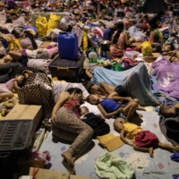 Residents affected by the onslaught of Typhoon Vamco sleep at a basketball court turned into an evacuation center, in San Mateo, Philippines, on Saturday.  | REUTERS