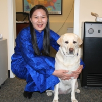 All dressed up: Uyanga Erdenebold hugs her previous guide dog, Gladys, for Deel Day. A deel is a traditional piece of Mongolian clothing.  | COURTESY OF UYANGA ERDENEBOLD 