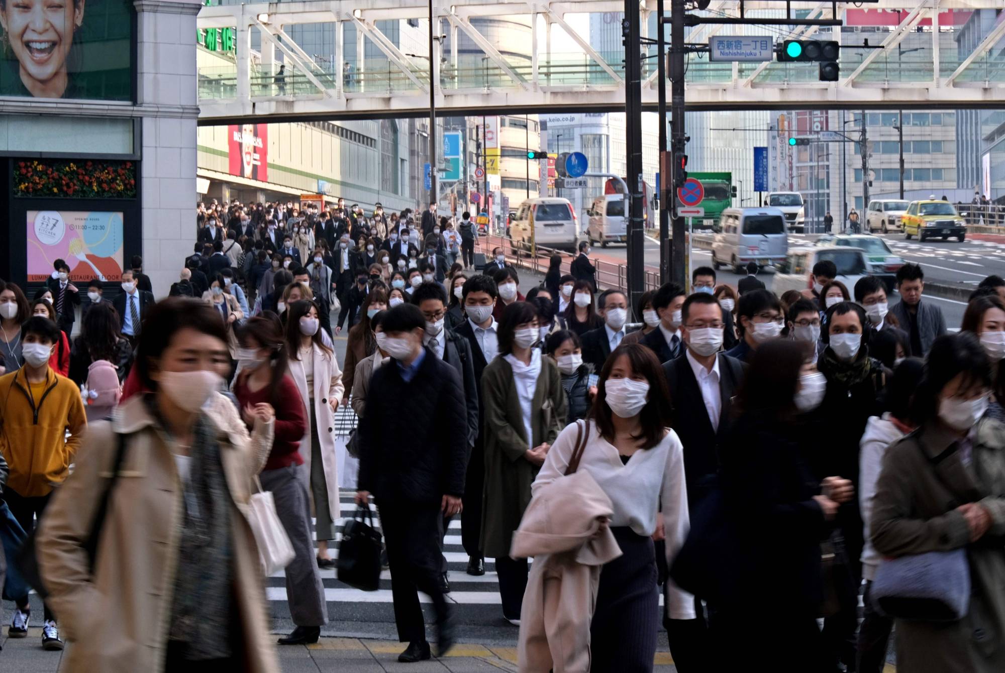 Commuters wearing masks near Shinjuku Station in Tokyo in June | AFP-JIJI