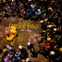 Members of the media take pictures of a clown on an inflatable oversized duck as pro-democracy protesters take part in an anti-government rally in Bangkok on Wednesday.  | AFP-JIJI