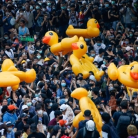 Pro-democracy demonstrators move inflatable rubber ducks during a rally in Bangkok on Wednesday.  | REUTERS 