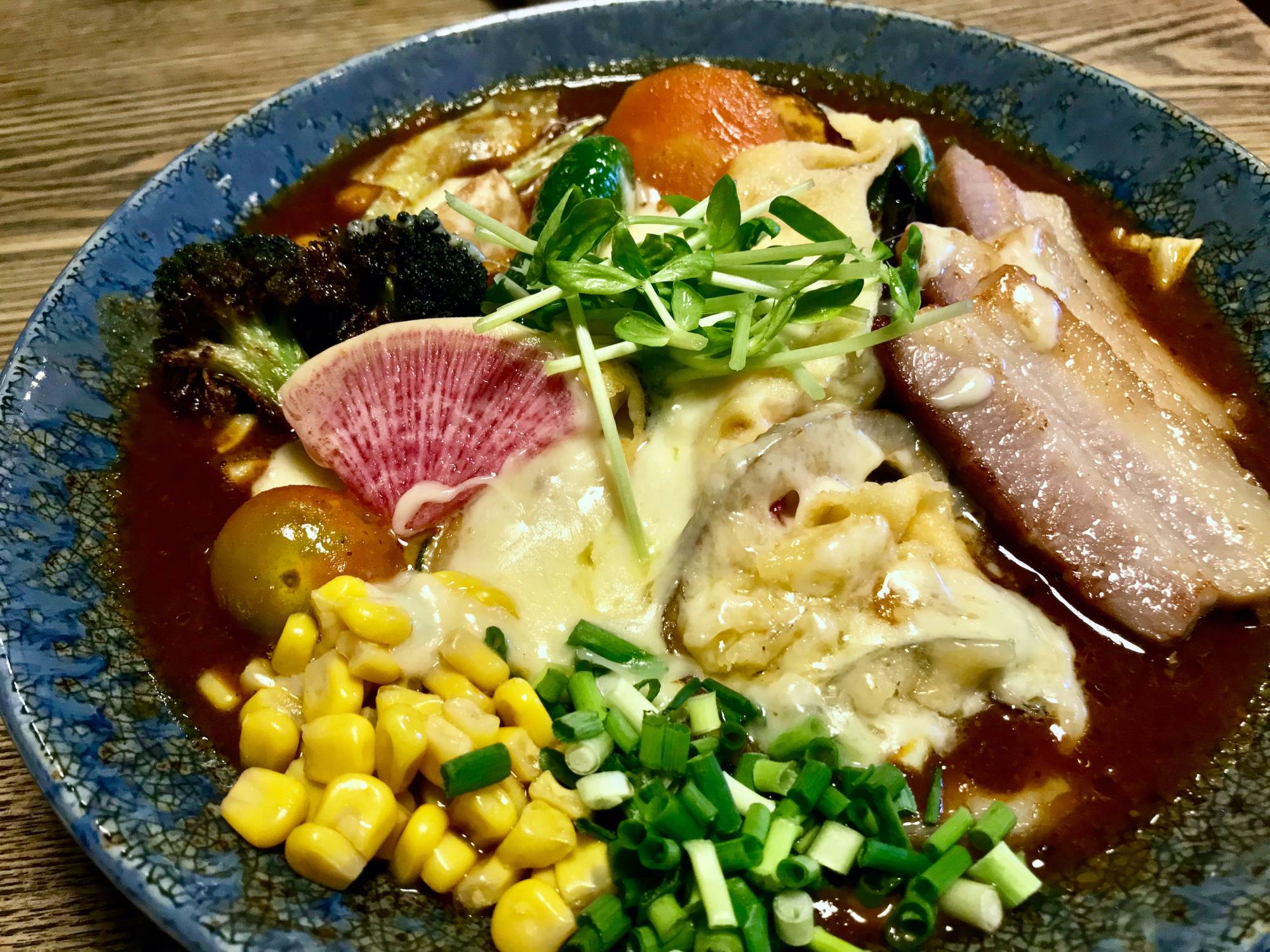 Pony up: No bowl at Ponipirica would be complete without the addition of tappuri-yasai (“lots of vegetables”) and a blanket of cheese. | Florentyna Leow 