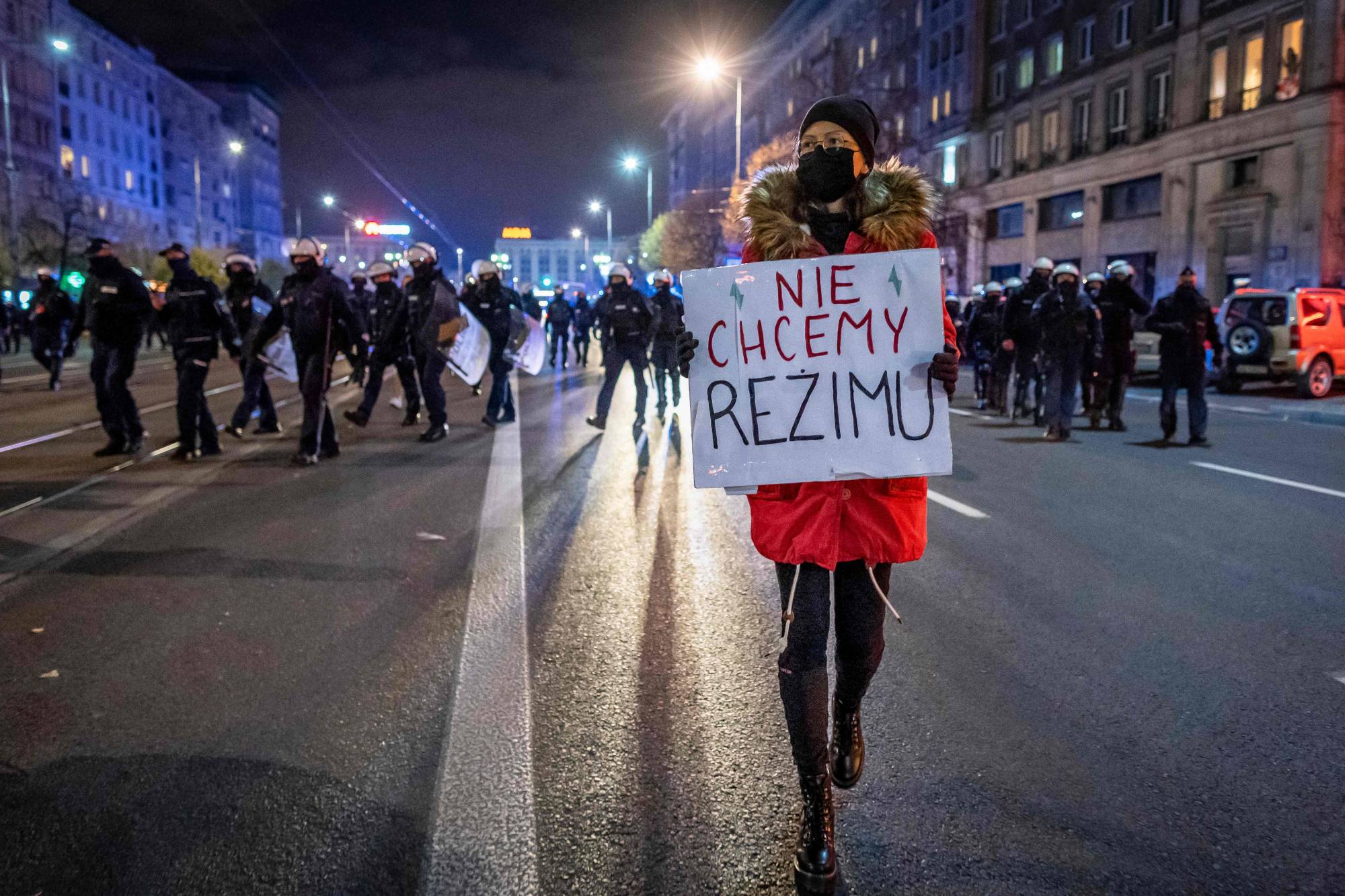 A demonstrator holds a placard next to police officers during a pro-choice protest in the streets of central Warsaw earlier this month. | AFP-JIJI