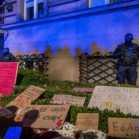 Police officers stand guard in front of the Education Ministry where protesters left banners, earlier this month in Warsaw.  | AFP-JIJI