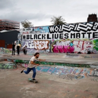 A man skateboards against the back drop of a Black Lives Matter mural in Liverpool, England, in September.  | REUTERS