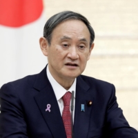 Prime Minister Yoshihide Suga speaks at a  news conference in Tokyo on Nov. 17.  | POOL / VIA REUTERS 