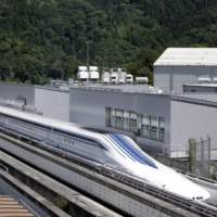 A maglev train travels along on a track during a trial run at the Yamanashi Maglev Test Track site in Tsuru, Yamanashi Prefecture.  | BLOOMBERG