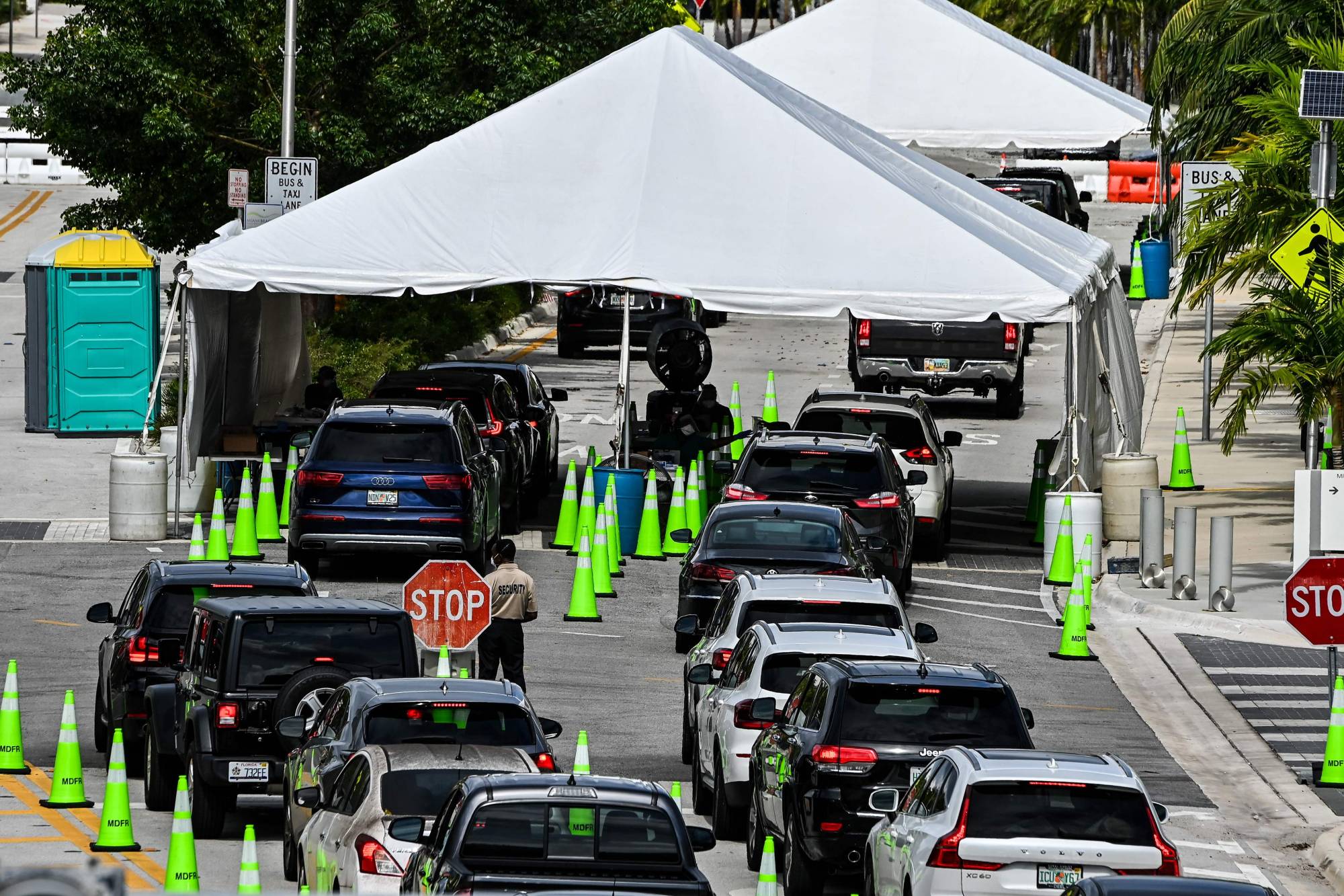 People wait inside vehicles at a drive-through COVID-19 testing site in Miami Beach, Florida, on Nov. 17. | AFP-JIJI