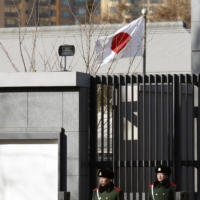 Paramilitary policemen stand guard in front of the Japanese Embassy in Beijing in December 2013.  | REUTERS