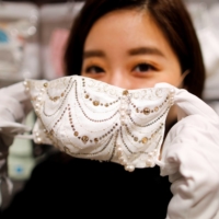 Cox Co.\'s luxury face mask features diamond, platinum and Swarovski crystals, and sells for ¥1 million. | REUTERS