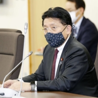 Takuya Hirai, minister in charge of digitalization, speaks Thursday in Tokyo at a task force meeting to prepare for the creation of the digital agency. | KYODO