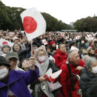 People gather at the Imperial Palace in Tokyo on Jan. 2 to see Emperor Naruhito and his family to greet the public at New Year. | KYODO