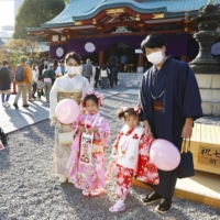 A family visits Hie Shrine in Chiyoda Ward in Tokyo on Nov. 15 for a festival celebrating children of 3, 5 and 7 years of age. | KYODO