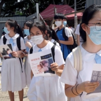 Students march near Heung To Middle School in Hong Kong in June to protest against what the students say is the nonrenewal of a teacher\'s contract over her political beliefs. | REUTERS 